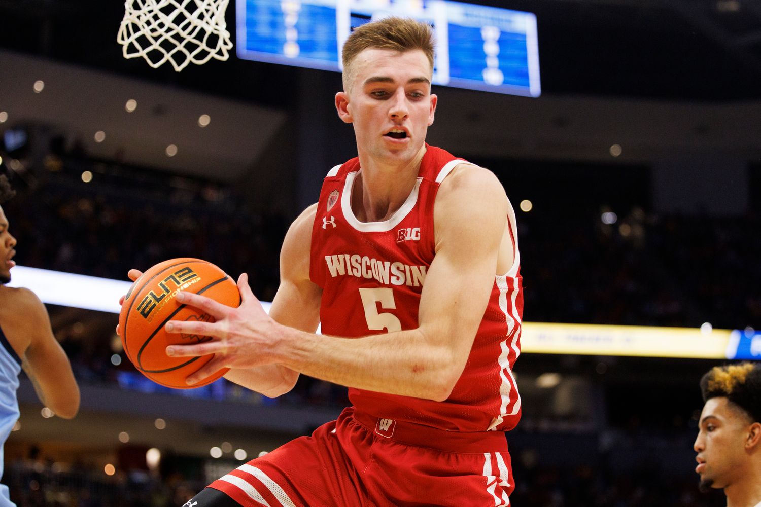 Wisconsin forward Tyler Wahl grabbing the basketball against Marquette.